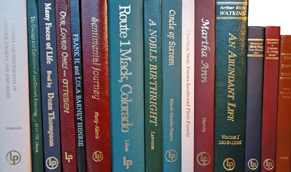 Row of books with visible titles and authors on a white background