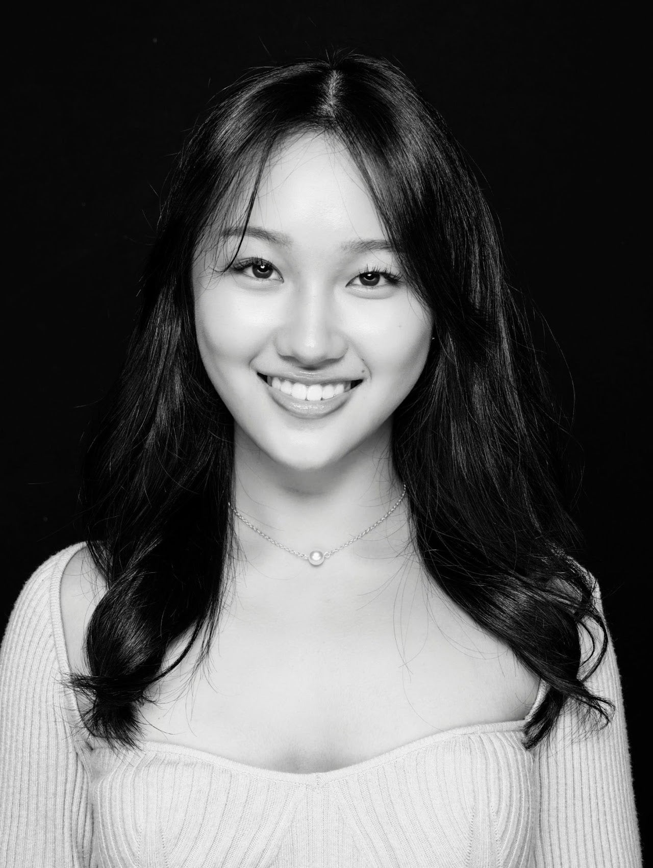 Black and white photo of a girl with long black hair.